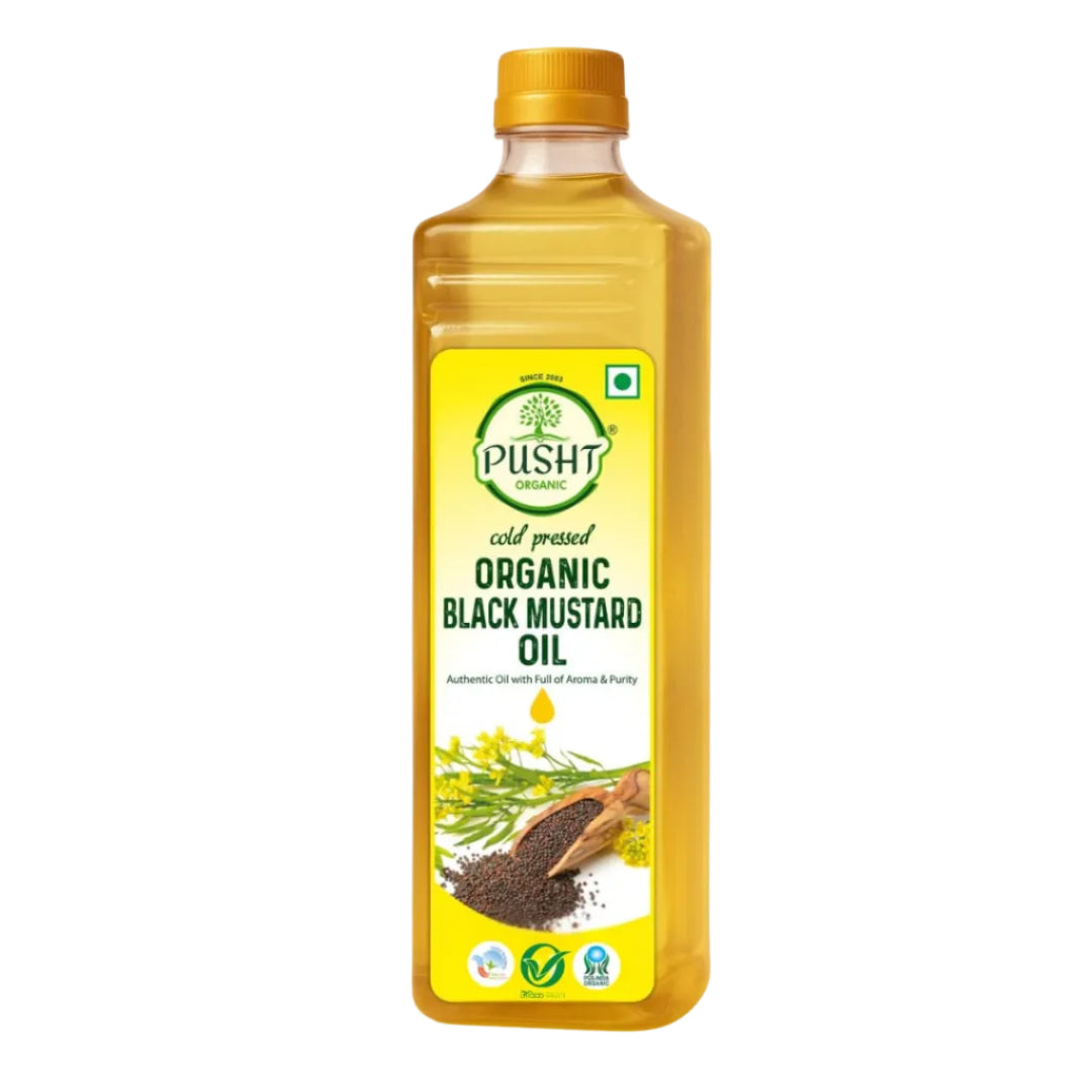A bottle of Pusht Organic Cold Pressed Organic Black Mustard Oil on a plain white background. The bottle is filled with golden-yellow oil and features a yellow label with green and black text, along with illustrations of mustard seeds and flowers.